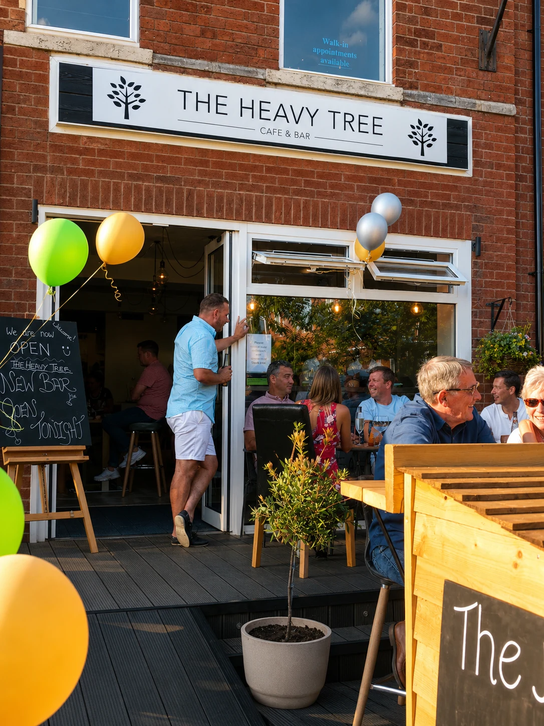 The Heavy Tree exterior with outdoor tables, diners and balloons