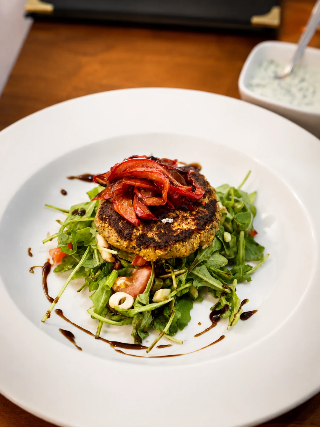 Grilled vegetable patty with roasted peppers and salad