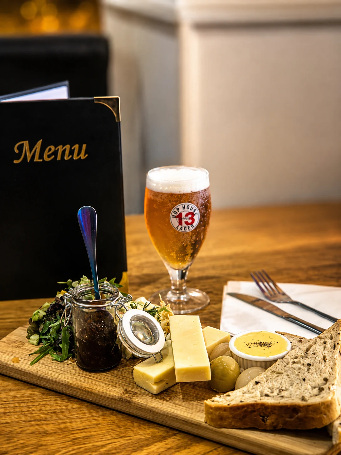 Hop House lager with a cheese board, salad and bread